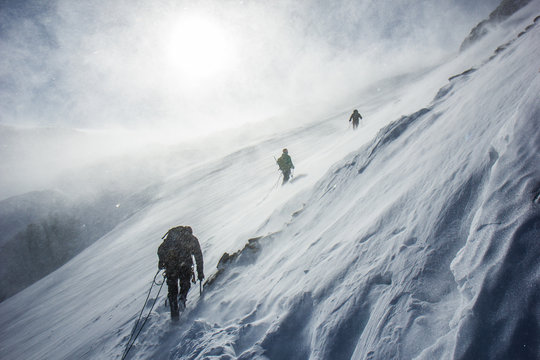 Hiker overlooking a vast mountain valley in the Alps